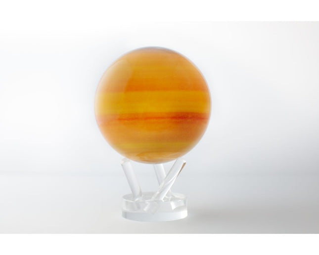 Light-powered MOVA Globes rotating on acrylic stand with detailed satellite imagery and planetary designs at Raven’s Cauldron.