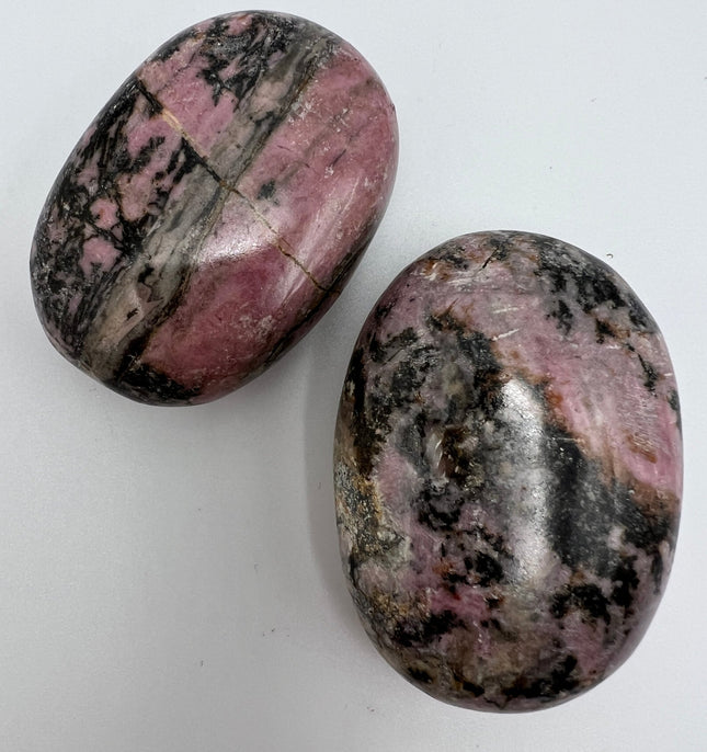 Rhodonite palm stone - Raven's Cauldron